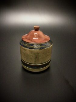 mid fired ceramic jar with a lid turned from salvaged Sea Grape.