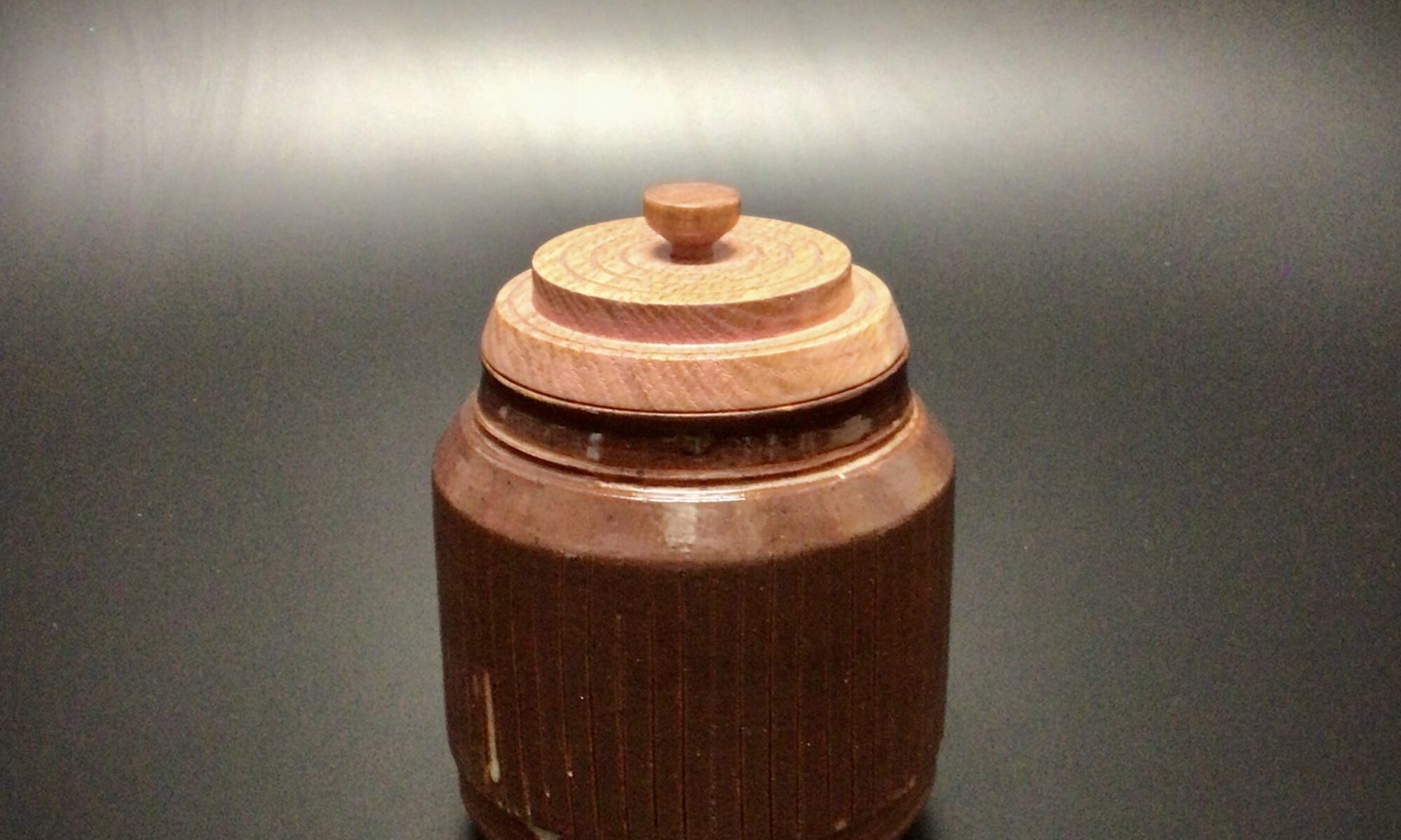 Glazed mid fired ceramic jar with an acrylic latex tinted, turned ash lid and a turned hickory knob