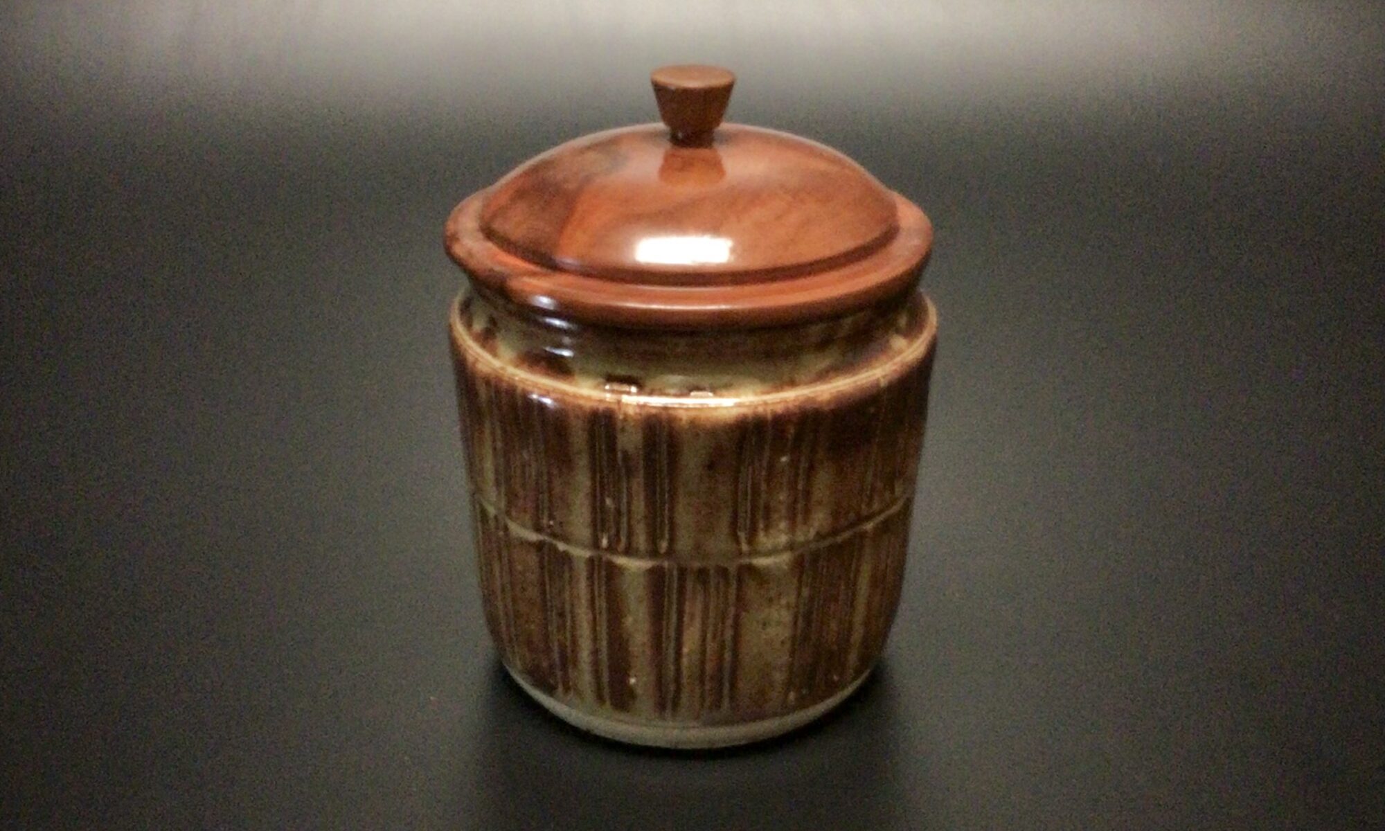 Glazed mid fired ceramic jar with a turned sea grape lid and turned chestnut knob