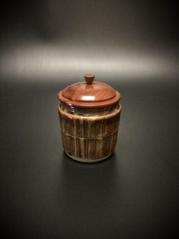 Glazed mid fired ceramic jar with a turned sea grape lid and turned chestnut knob